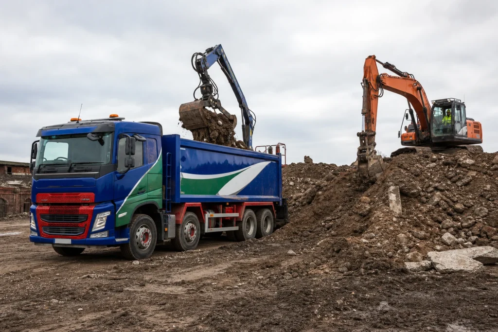 Grab lorry loading excavation spoil from a construction site.
